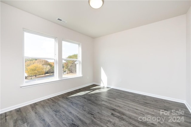 unfurnished room featuring dark hardwood / wood-style floors