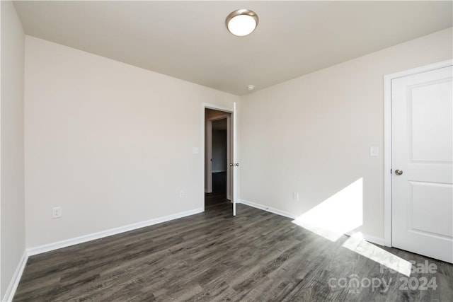 spare room featuring dark hardwood / wood-style floors