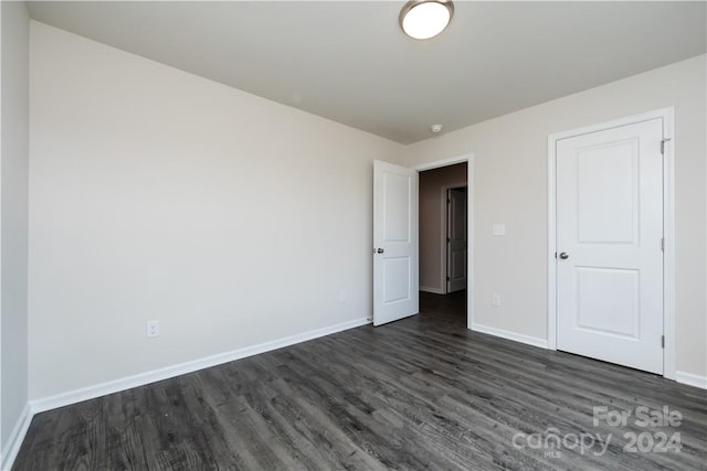 unfurnished bedroom featuring dark hardwood / wood-style flooring