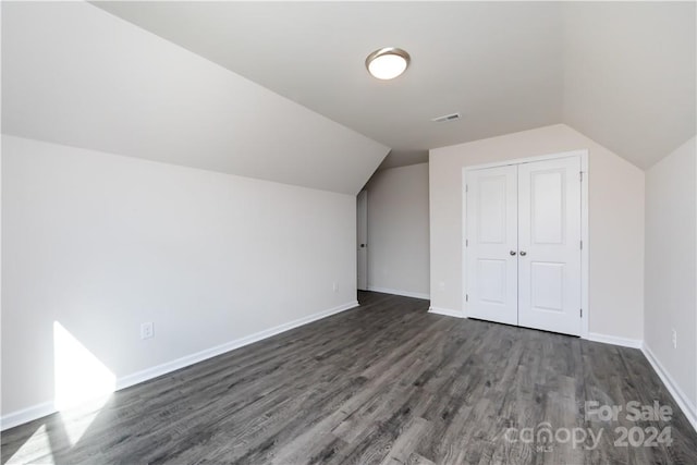 bonus room featuring lofted ceiling and dark hardwood / wood-style flooring