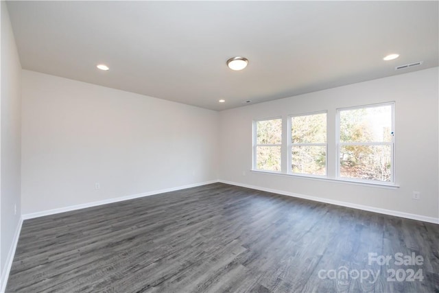 empty room featuring dark hardwood / wood-style flooring