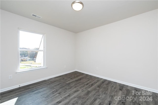 spare room featuring dark hardwood / wood-style flooring