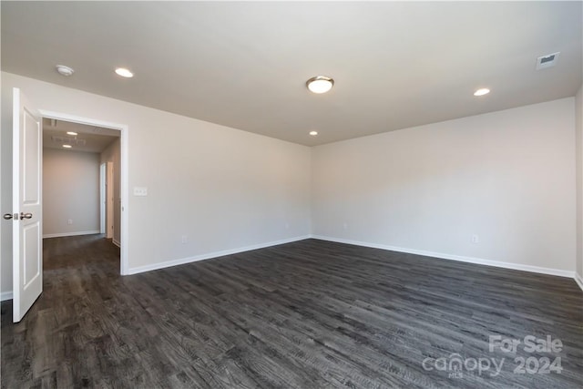 spare room with dark wood-type flooring