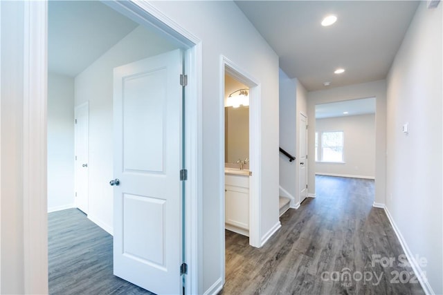 hall with dark hardwood / wood-style floors and sink