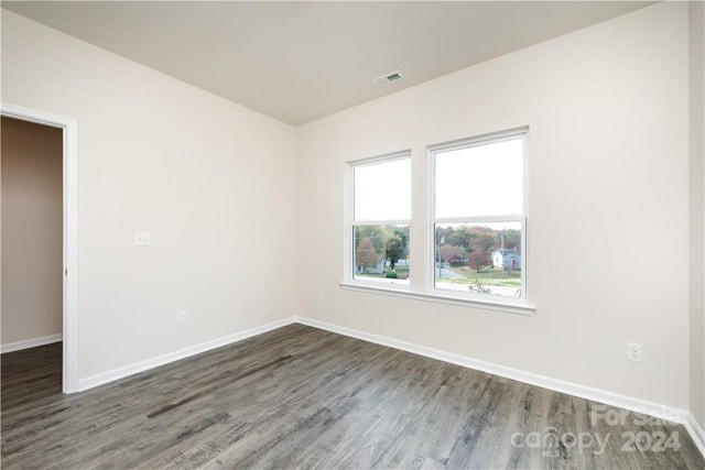 unfurnished room featuring dark hardwood / wood-style flooring