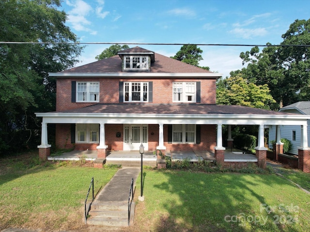 view of front of home featuring a front yard and covered porch