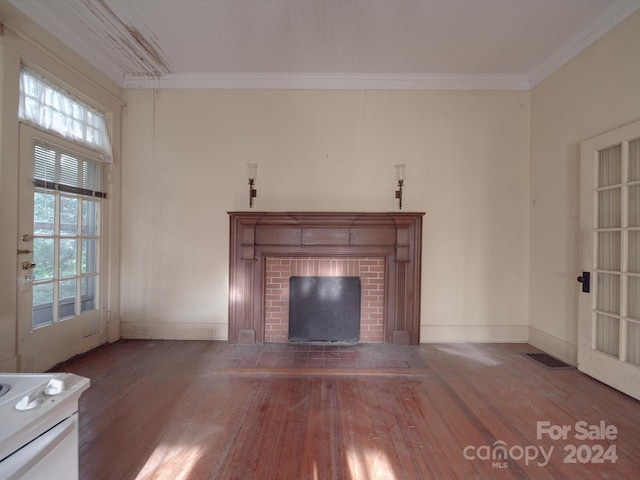 unfurnished living room with ornamental molding, dark wood-style flooring, a fireplace, and visible vents