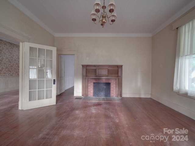 unfurnished living room featuring ornamental molding, a fireplace, and wood finished floors