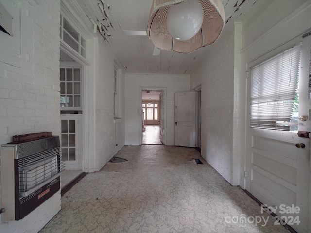 foyer with brick wall and heating unit