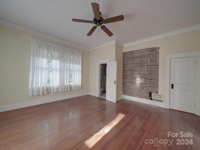 interior space featuring dark wood finished floors, crown molding, and baseboards