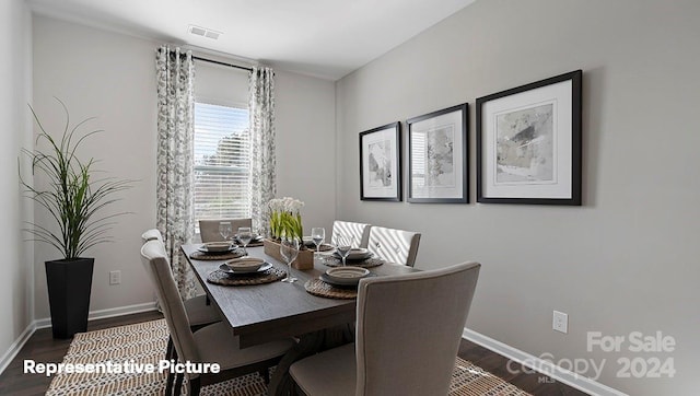 dining area with dark wood-type flooring