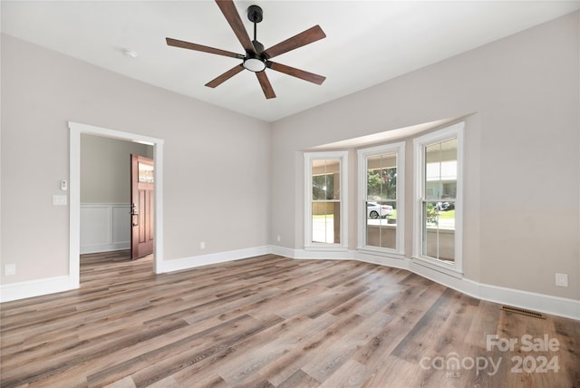 unfurnished room featuring hardwood / wood-style floors and ceiling fan