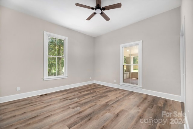 spare room with ceiling fan and wood-type flooring