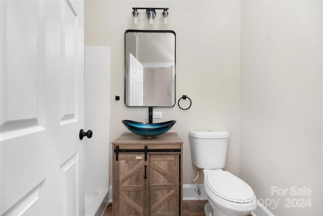 bathroom featuring hardwood / wood-style floors, toilet, and vanity