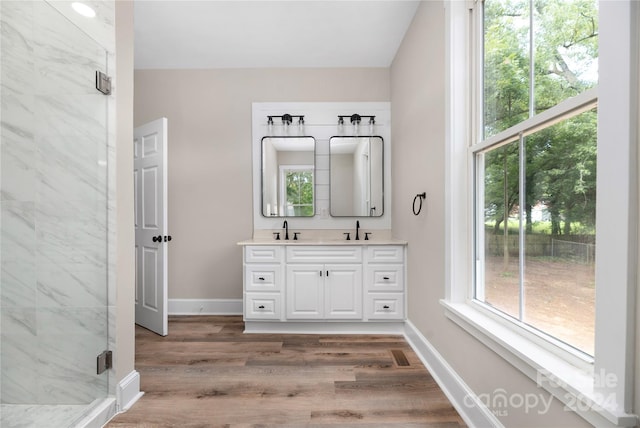 bathroom featuring a shower with door, vanity, and wood-type flooring