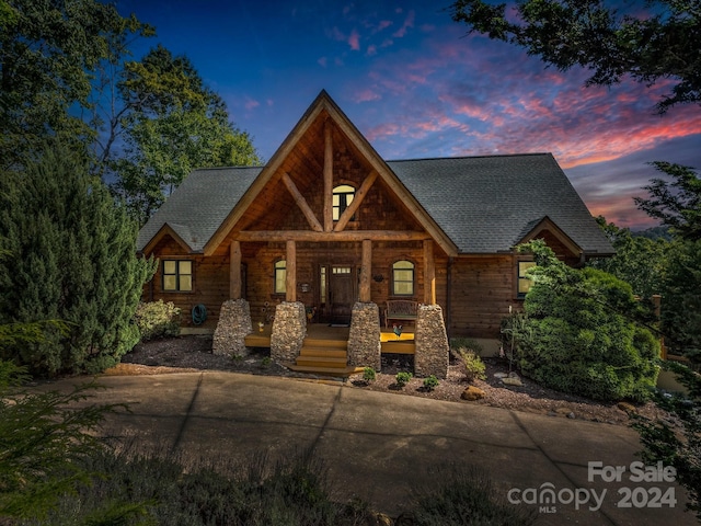 view of front of house with a porch and roof with shingles