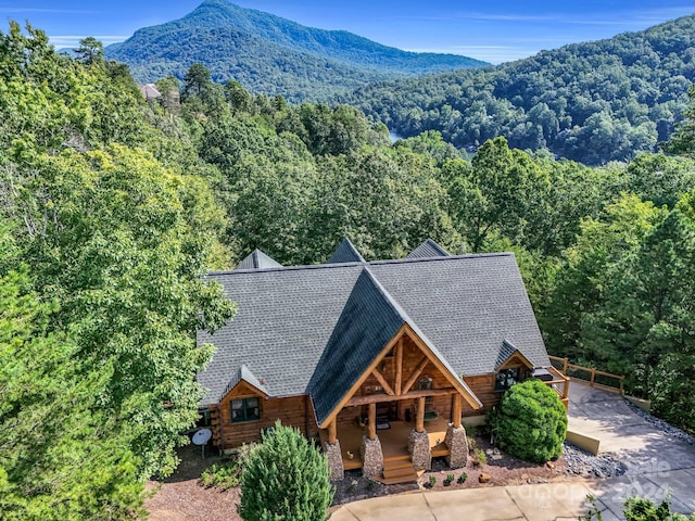 exterior space featuring a wooded view