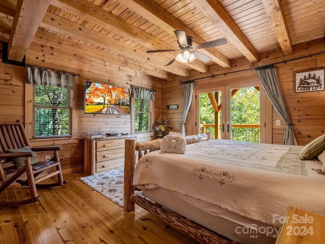 bedroom with access to outside, light wood finished floors, wooden ceiling, and wooden walls