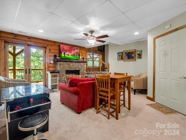 living room featuring carpet flooring, ceiling fan, and a paneled ceiling