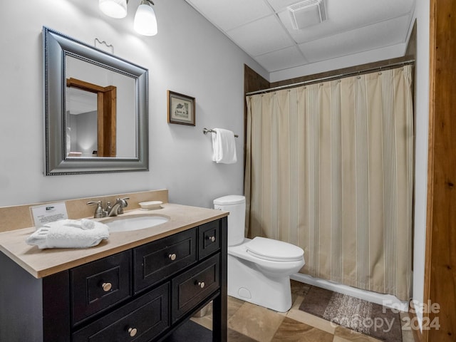 full bath with a drop ceiling, toilet, vanity, visible vents, and a shower with curtain