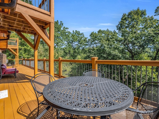 wooden terrace with outdoor dining area