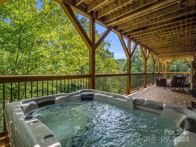 exterior space featuring a hot tub and a deck