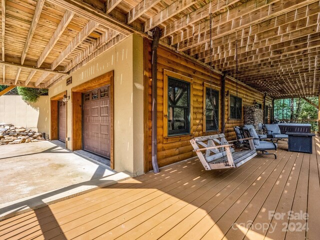 wooden terrace featuring a garage