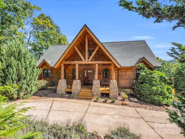 view of front of house with covered porch and a shingled roof