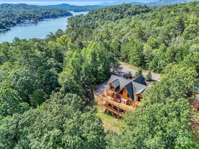 drone / aerial view featuring a water view and a forest view