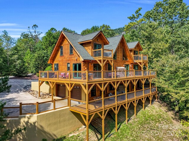 219 Highland Hts, Lake Lure, NC 28746 - rear view of property with a balcony, log siding, a shingled roof, and a garage