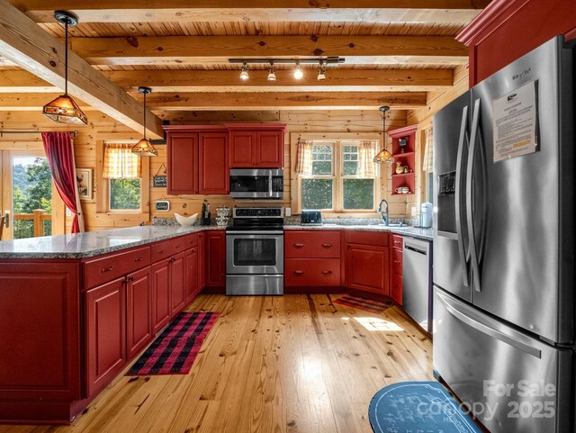 219 Highland Hts, Lake Lure, NC 28746 - kitchen with appliances with stainless steel finishes, light wood finished floors, healthy amount of natural light, wood walls, and a sink