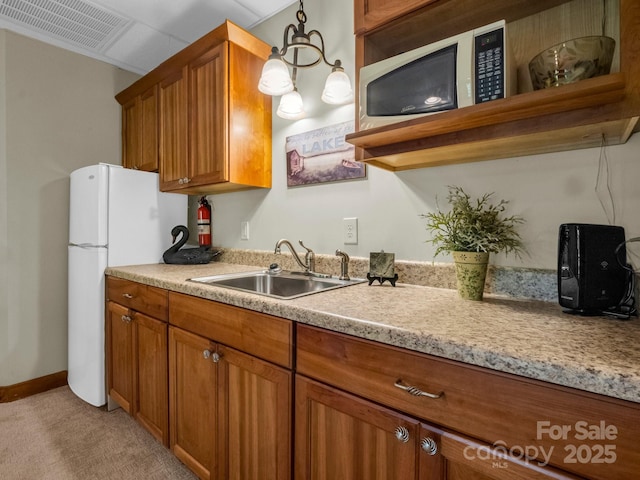 219 Highland Hts, Lake Lure, NC 28746 - kitchen with a sink, brown cabinets, light countertops, and freestanding refrigerator