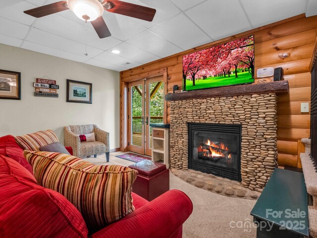 219 Highland Hts, Lake Lure, NC 28746 - living area with rustic walls, a fireplace, carpet, and ceiling fan