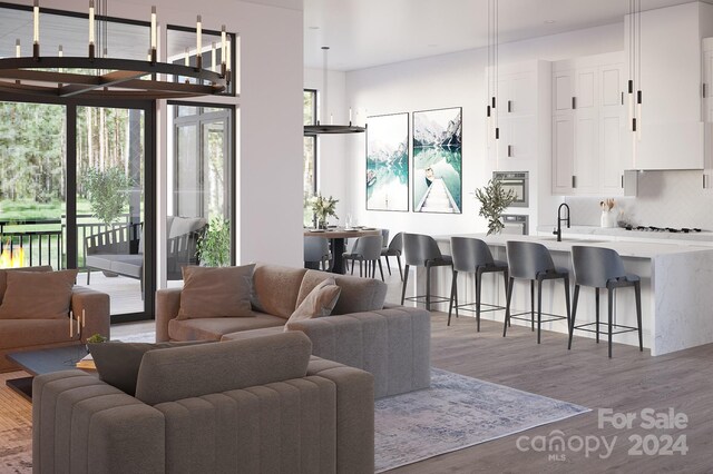 living room with sink and light hardwood / wood-style flooring