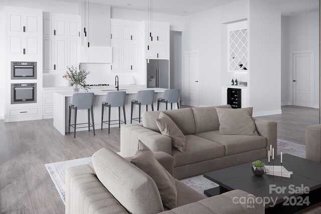 living room featuring sink and light wood-type flooring