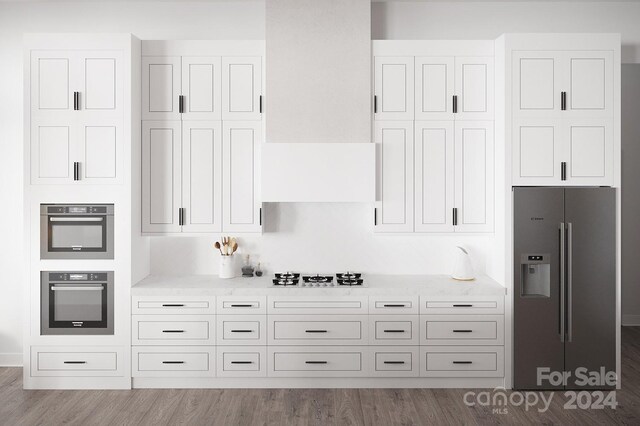 kitchen featuring light hardwood / wood-style flooring, white cabinetry, light stone counters, and stainless steel appliances