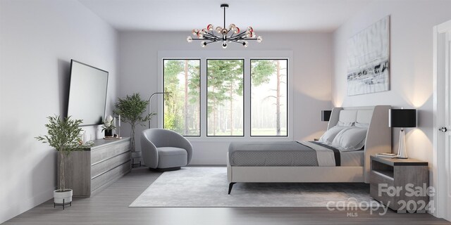 bedroom with an inviting chandelier and light hardwood / wood-style flooring