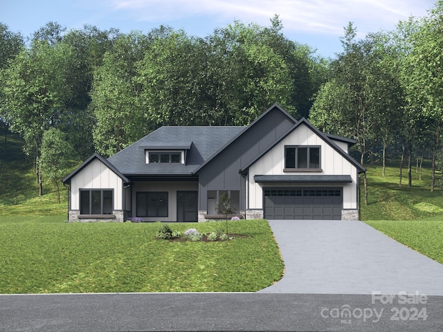 modern farmhouse style home featuring driveway, a front lawn, stone siding, board and batten siding, and an attached garage