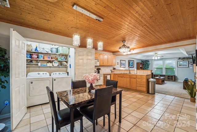 dining space featuring wood ceiling, ceiling fan, light tile patterned flooring, and washer and clothes dryer