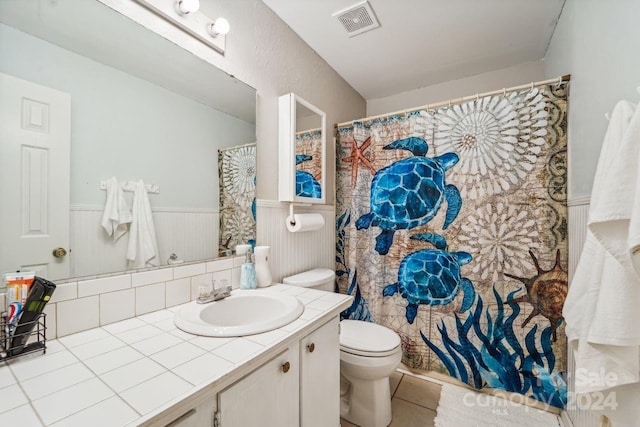 bathroom with tile patterned floors, vanity, and toilet