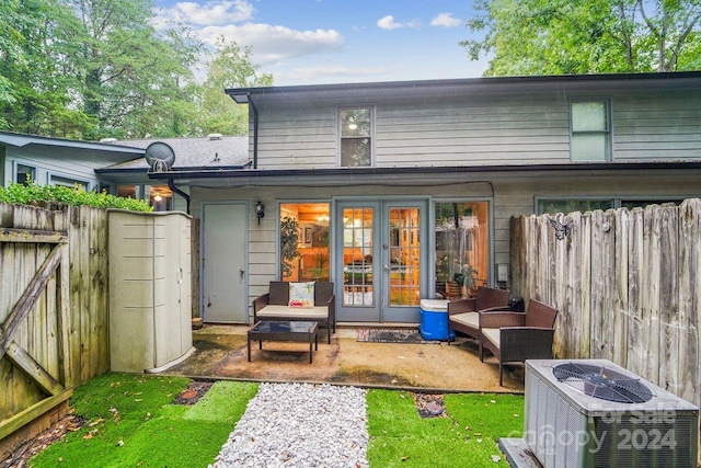 rear view of house with an outdoor fire pit, central AC, and a patio area