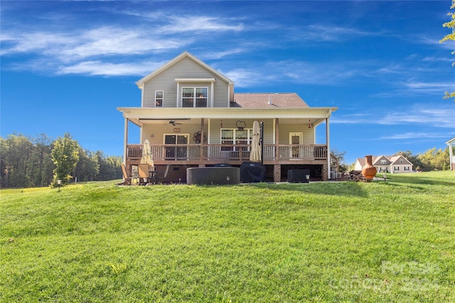 back of house with ceiling fan, a porch, and a lawn