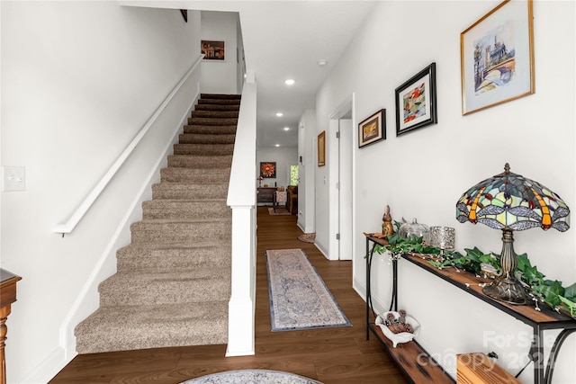 stairway with hardwood / wood-style floors