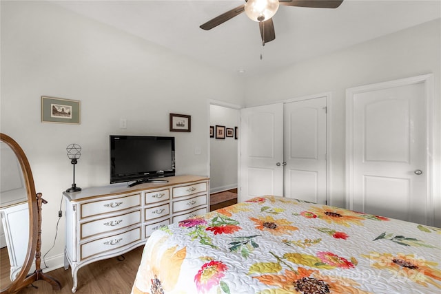 bedroom featuring a closet, ceiling fan, and dark hardwood / wood-style flooring