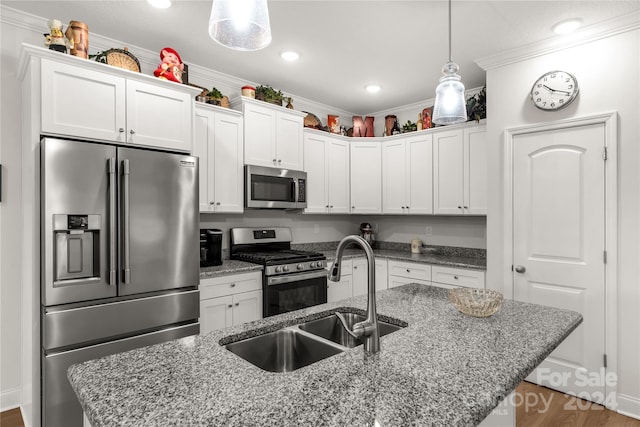 kitchen featuring sink, white cabinetry, appliances with stainless steel finishes, and hardwood / wood-style floors