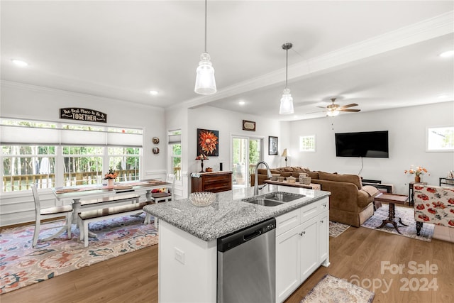 kitchen with light hardwood / wood-style flooring, stainless steel dishwasher, sink, plenty of natural light, and white cabinets