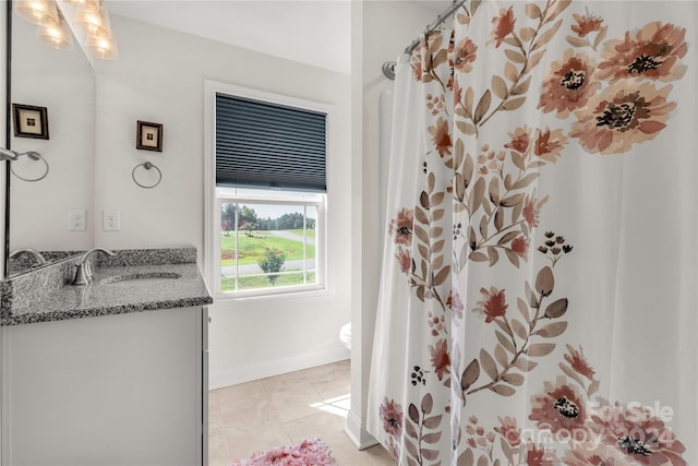 bathroom featuring tile patterned floors, toilet, and vanity