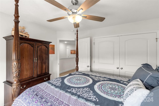 carpeted bedroom featuring ceiling fan and a closet