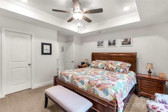 bedroom with ceiling fan, a raised ceiling, crown molding, and light colored carpet