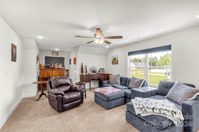 carpeted living room with ceiling fan